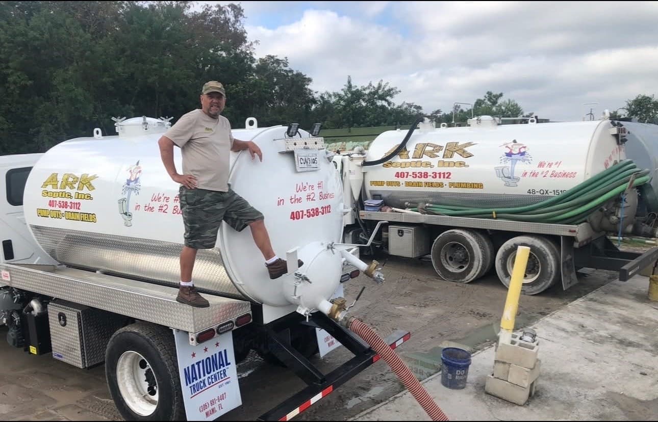 Ark Septic owner with company trucks