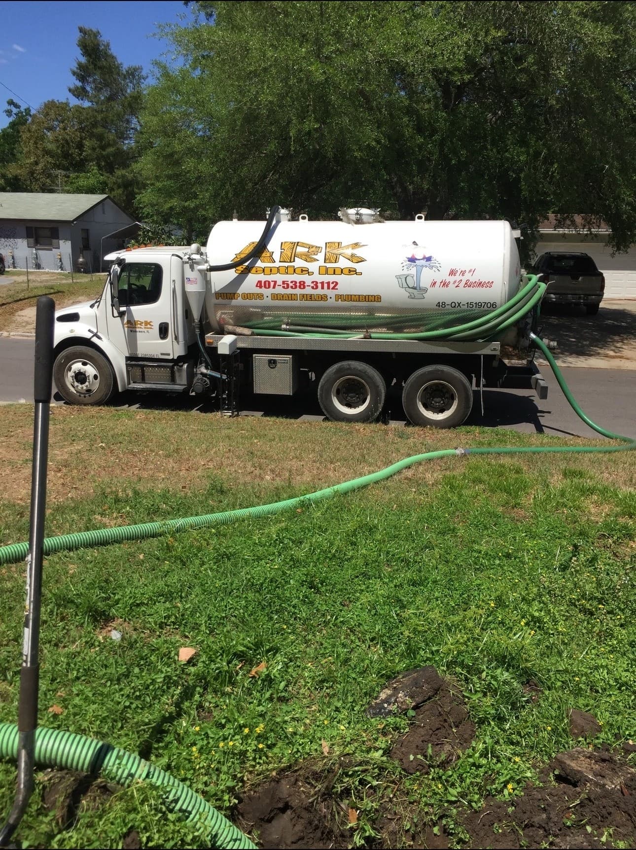 Ark Septic pump truck servicing a residential property